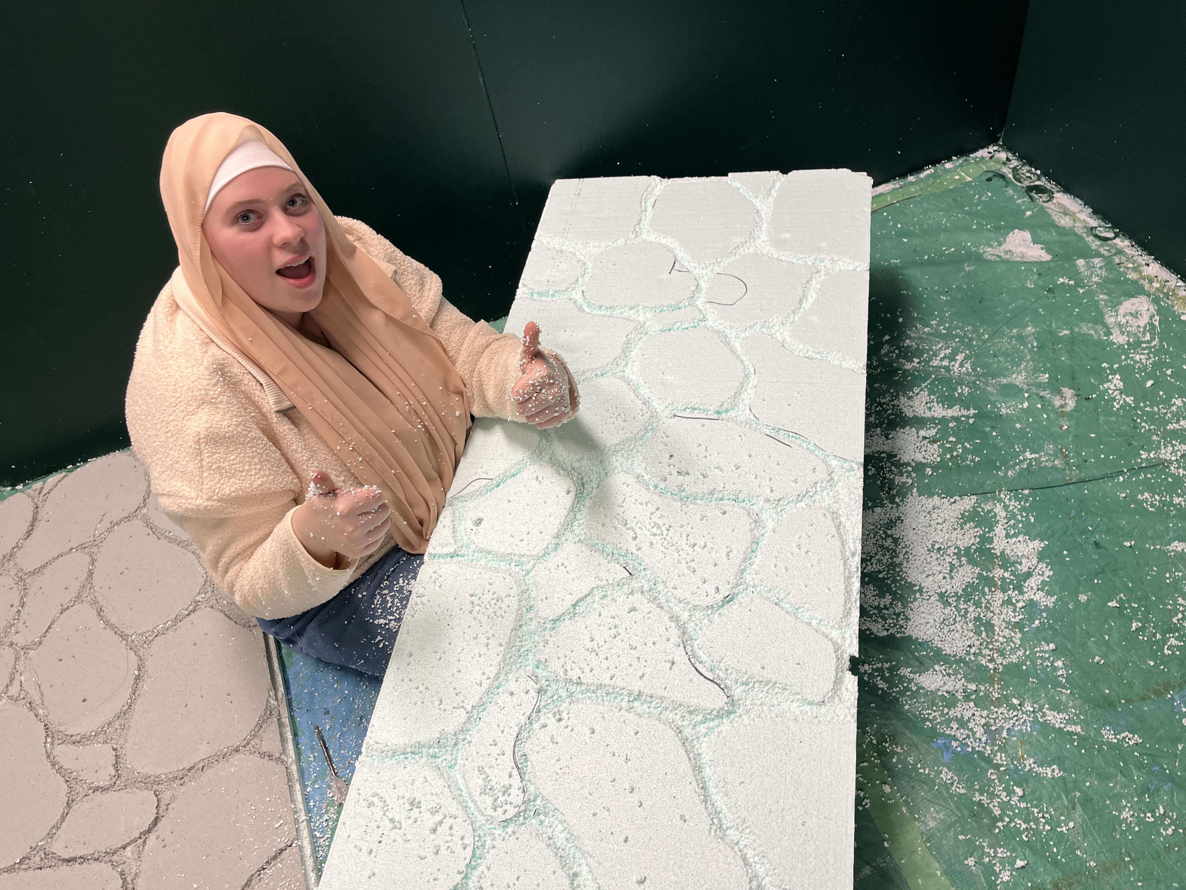 A team member sculpting the kiosk walls.